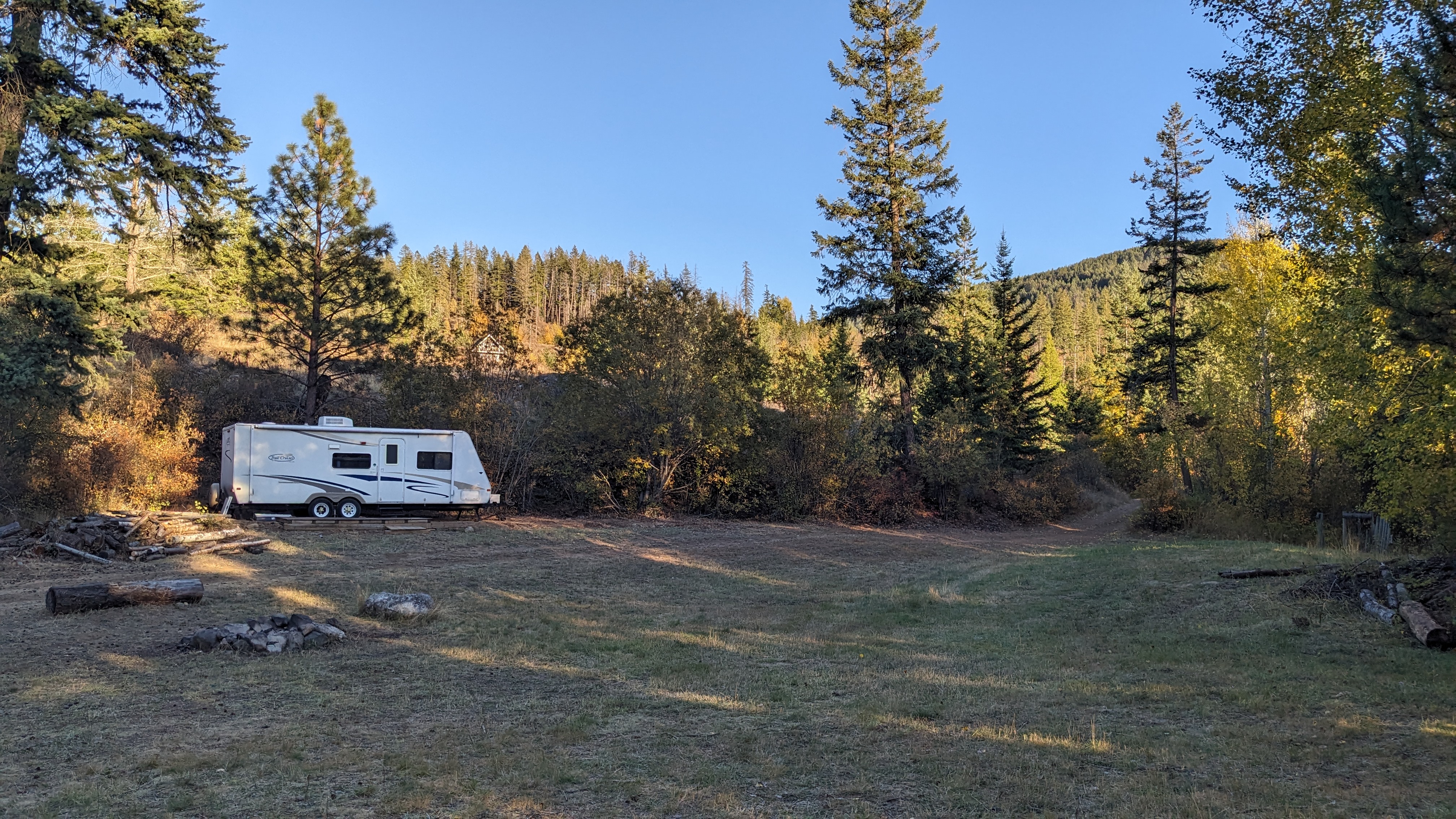 View across field showing a camping trailer set up